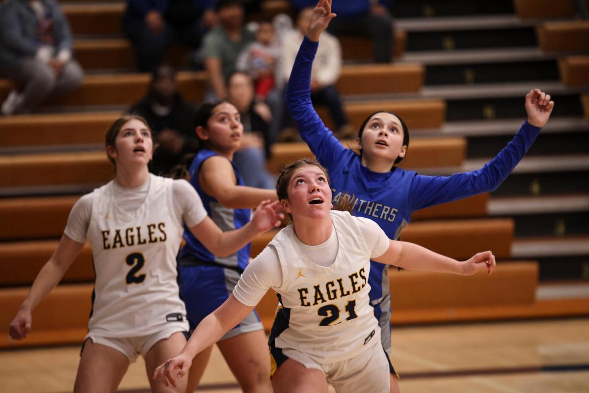 Ashlyn Waldram , left, and Brooklyn Waldram look for a rebound as Arroyo Grande fell to Caruthers 51-36 in a high school girls basketball playoff on Feb. 14, 2024.