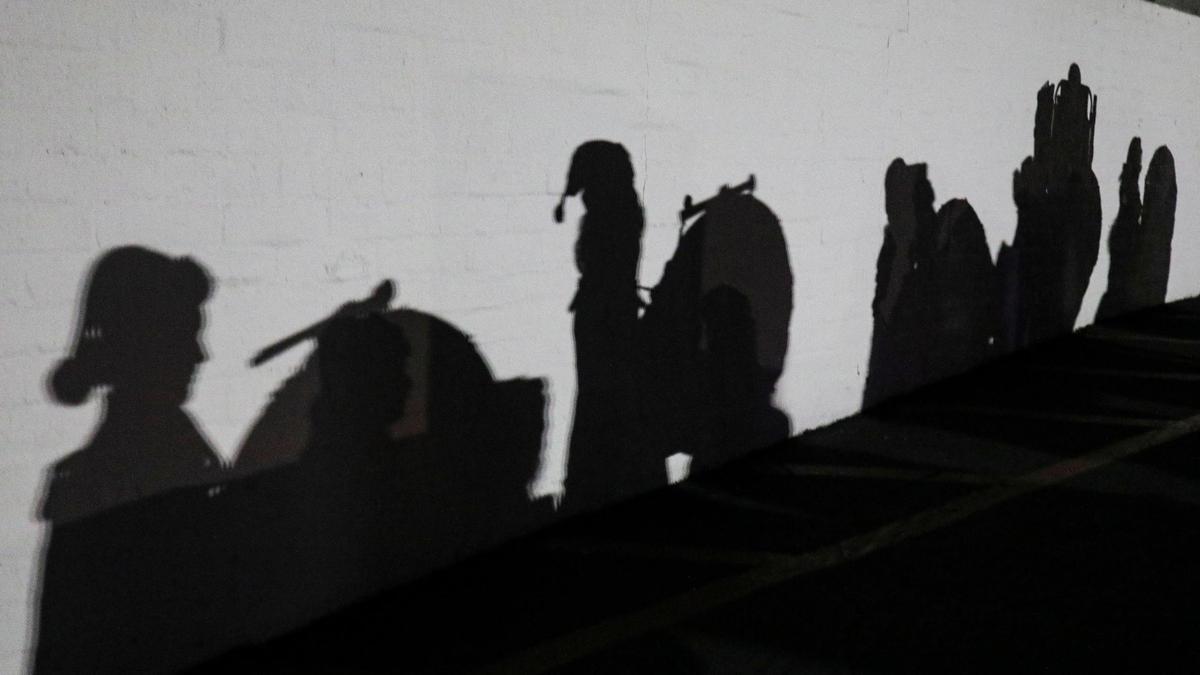 Shadows of the San Luis Obispo High School marching band fall on a wall as the students warmed up next to the Mission. San Luis Obispo held its 47th Annual Downtown Holiday Parade on Dec. 1, 2023, with the theme “Out of This World!”