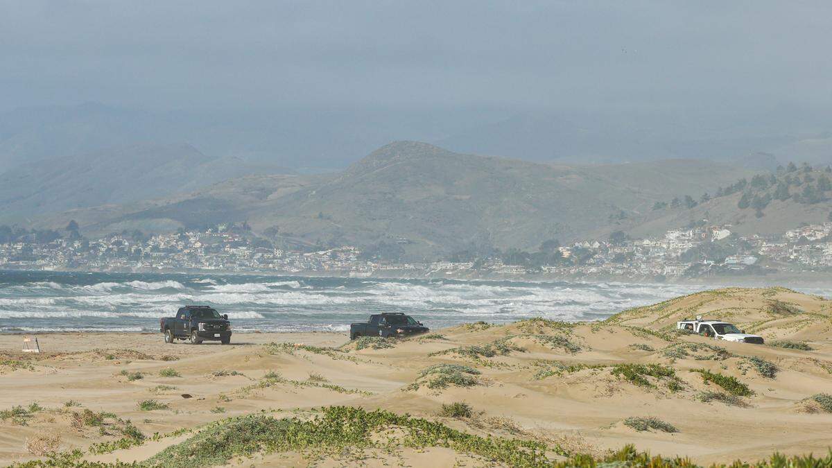 Investigators at the scene of a fatal shark attack north of Morro Rock. The water was closed Dec. 24, 2021.