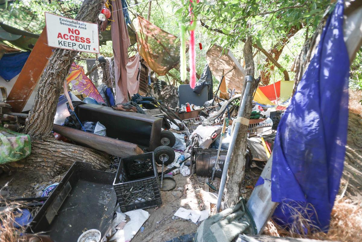 Members of the Paso Robles Police Department Community Action Team (CAT) and San Luis Obispo County Behavioral Health have stepped up outreach in the Salinas River, where there is fire risk and junk accumulation. This riverbed camp was abandoned.