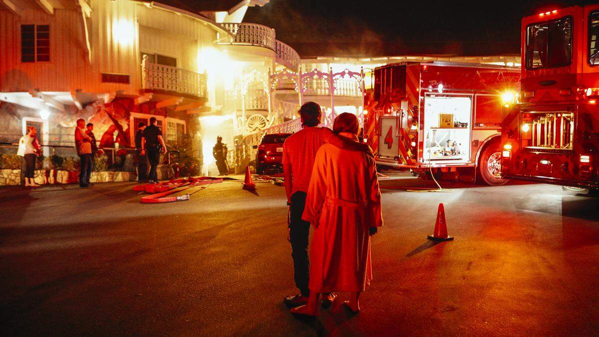 A couple watches as firefighters respond to a fire at the Madonna Inn on April 26. The blaze that started in an overfilled laundry room dryer was quickly extinguished with no injuries and only minor damage.