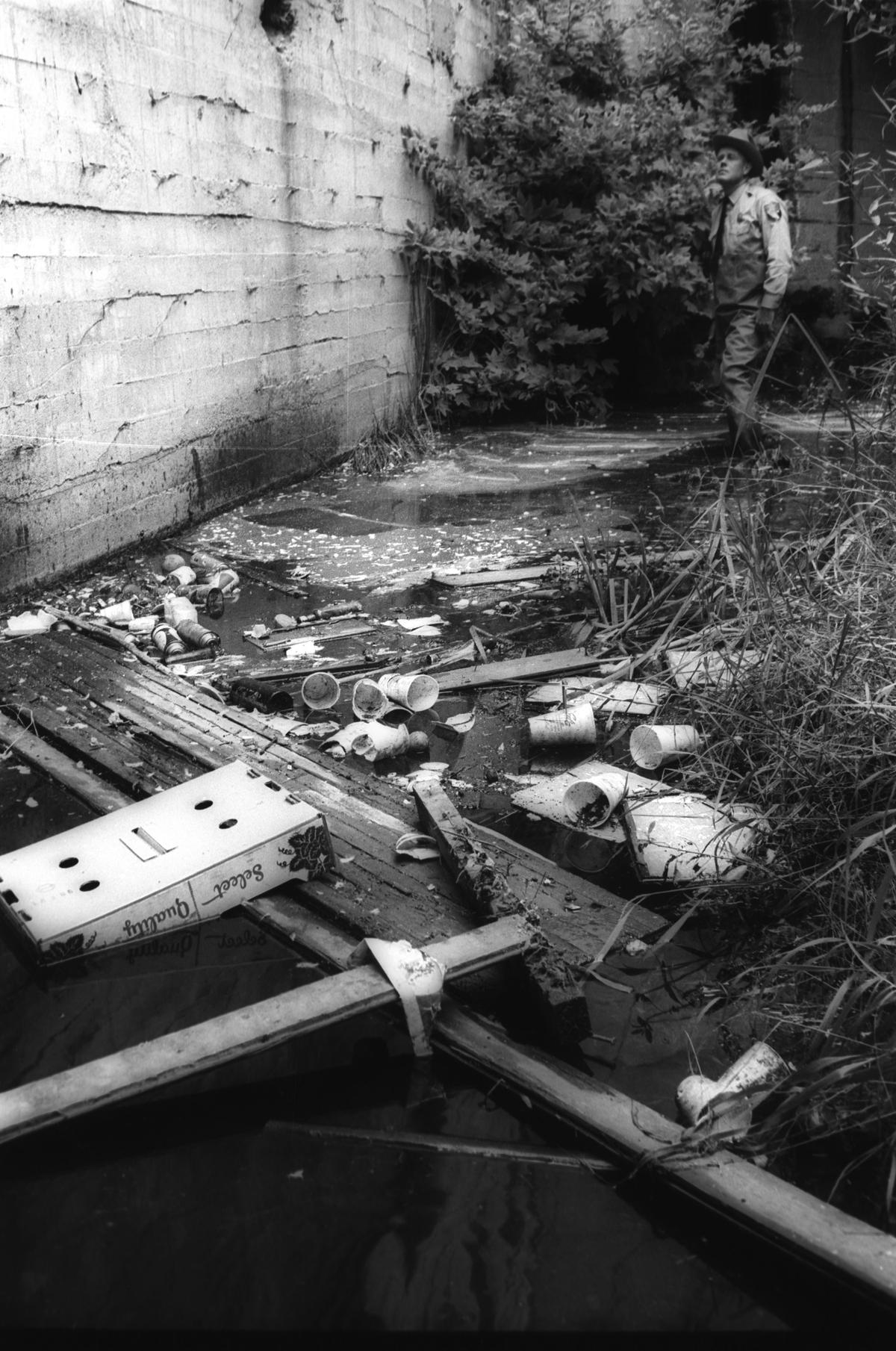 Howard Martin, Fish and Game Warden stood in San Luis Obispo Creek in Oct. 6, 1966, where it flows through the downtown heart of the city pointing to the trash and garbage which makes the stream an “open sewer.”