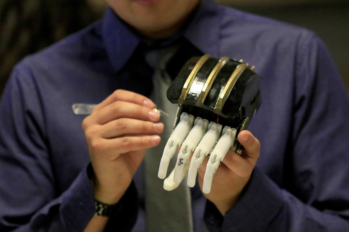 Ten-year-old Julian Reynoso lost his hands in a fiery car crash caused by a drunken driver. Some of his ability to be a kid again will be restored with new prosthetic hands created by Cal Poly engineering students. Austin Conrad tests the prosthetic hand just before Julian arrives to see the final product.