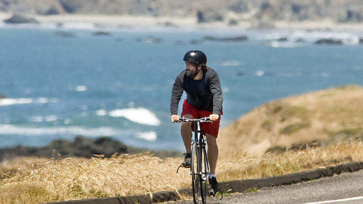 Tribune reporter Pat Pemberton tests the chip-sealed surface of Highway 1.
