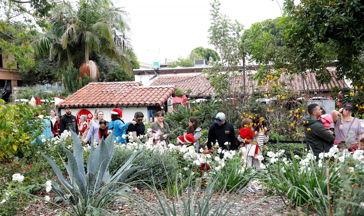 The line to see Santa Claus wound around Luna Red Restaurant. Joe Schacherer of Oceano, 79, has sat as Santa for 11 years at Downtown SLO’s Santa’s House in Mission Plaza. Schacherer started the team’s month-long gig on Nov. 29, 2024, with a fire engine ride, a walk through a holiday-lit tunnel and hundreds of excited children yelling for him.