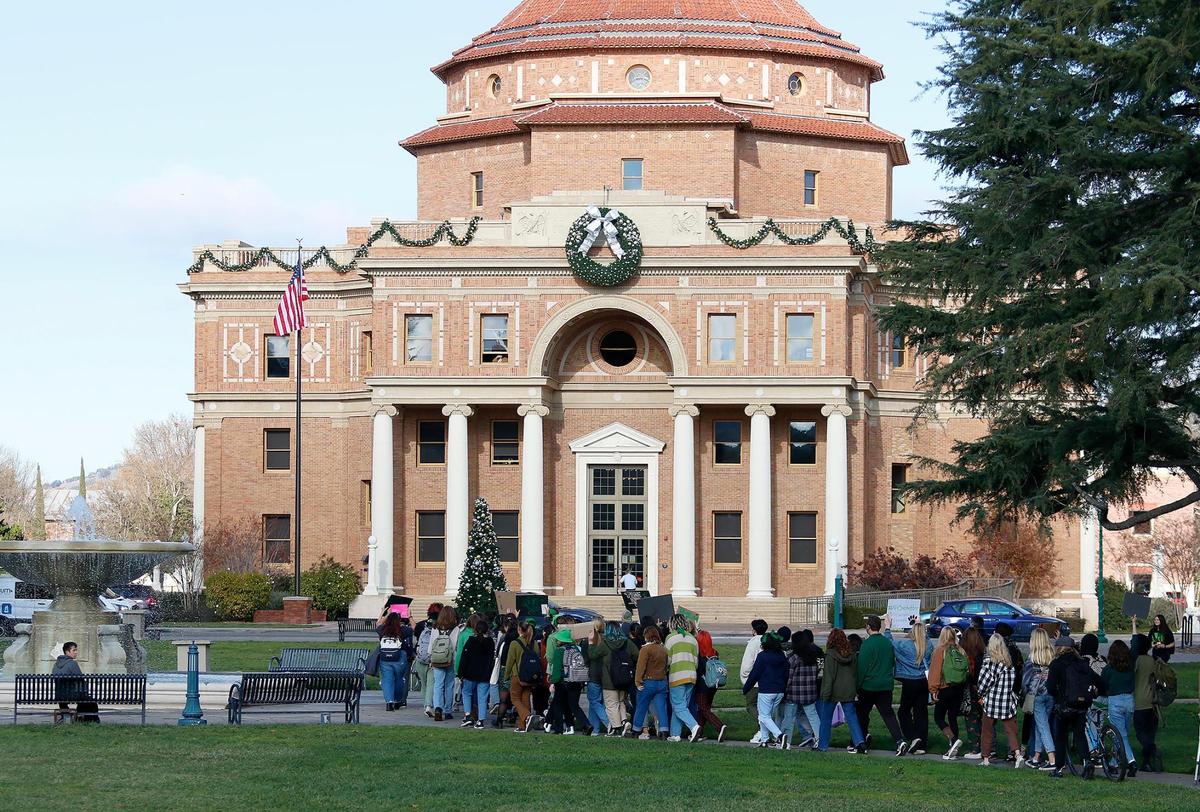 About 100 Atascadero High School students, alumni and parents walk to City Hall on Friday to protest incidents of sexual harassment, racism and homophobia revealed in anonymous stories on a new Instagram account.