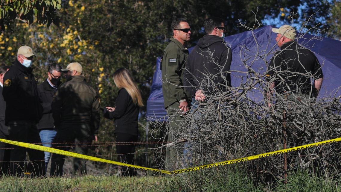San Luis Obispo County Sheriff Ian Parkinson, at center in dark glasses, talks to investigators on Tuesday, March 16, 2021, as investigators search the Arroyo Grande home of Ruben Flores, the father of Paul Flores, now considered the prime suspect in missing Cal Poly student Kristin Smart’s disappearance.