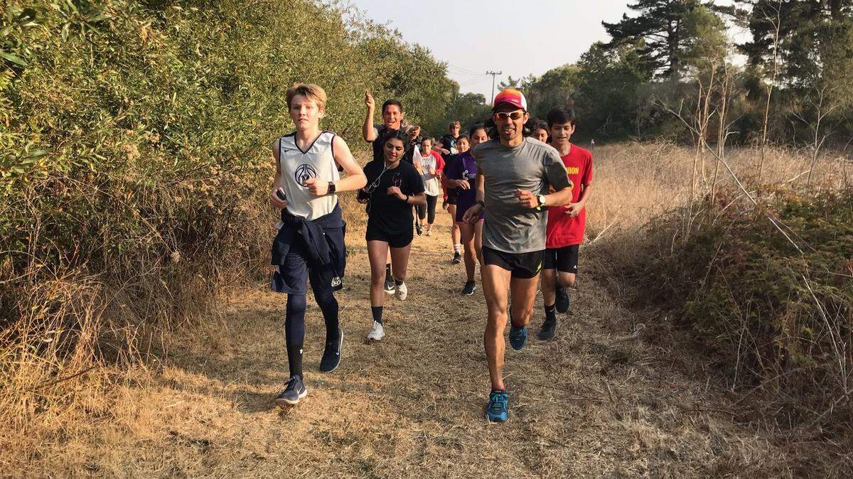 On the final leg of his 98-mile run, behind Coast Union High School, Mario Mendoza (front right) is joined by Cambria youths, including Ryan Kasper (front left) and Gabriela Cisneros (behind Kasper).