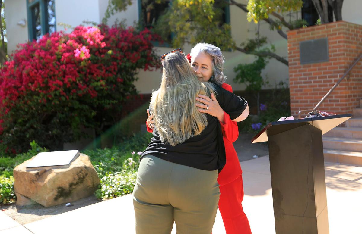 San Luis Obispo Mayor Heidi Harmon is hugged by a well-wisher. San Luis Obispo Mayor Heidi Harmon announced at a news conference on Thursday, Aug. 26, 2021, that she plans to step down as mayor. Her new position will be senior public affairs director with the Romero Institute, a law and public policy center.