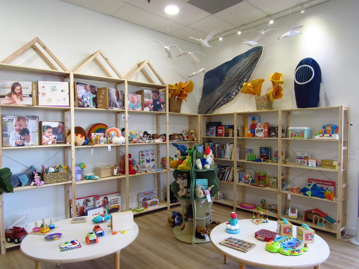 The toy and games section at Calico Kids is decorated with paper mache seagulls and a recycled denim whale.
