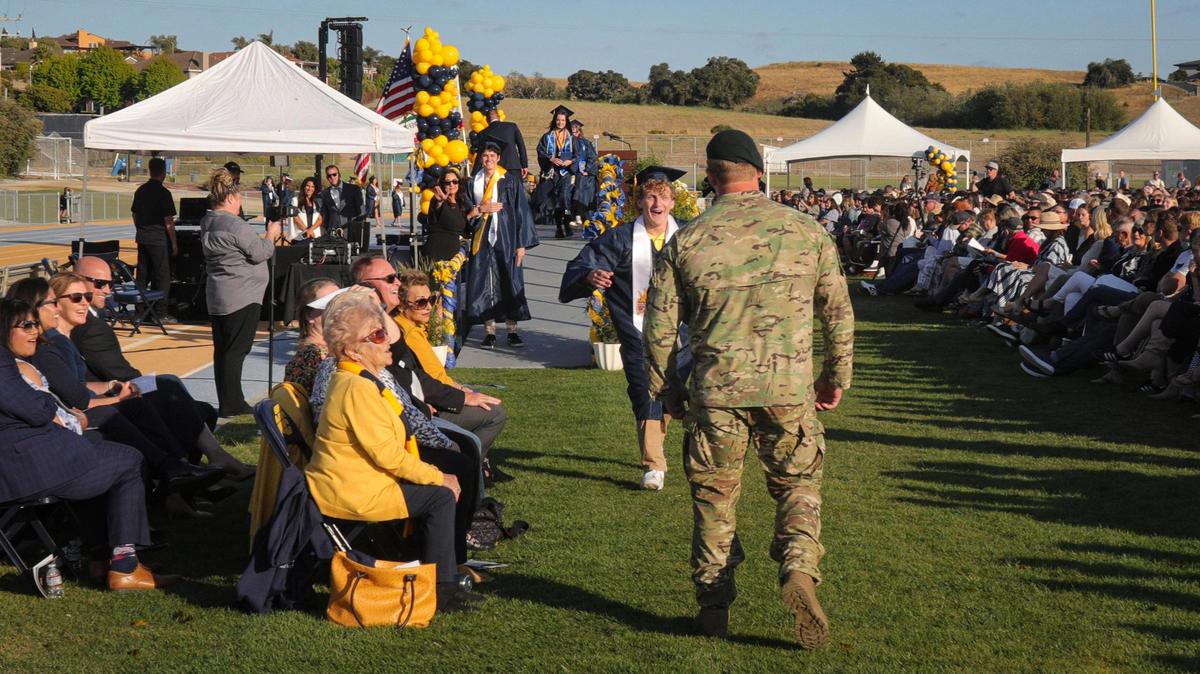 Graduate Max Tuggle gets a surprise hug from brother Theo, who got an unexpected leave from the U.S. Army to attend graduation. Arroyo Grande High School held commencement for 520 graduates on June 5, 2025.
