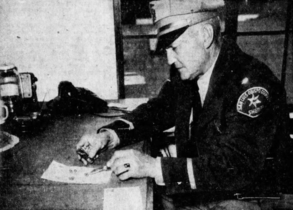 Lt. William Stonesifer of the San Luis Obispo County Sheriff’s Department examines buckshot recovered after he brought down a gunman with a shotgun blast. The suspect had fired several shots around Paso Robles wounding a woman in the early morning of June 14, 1956.