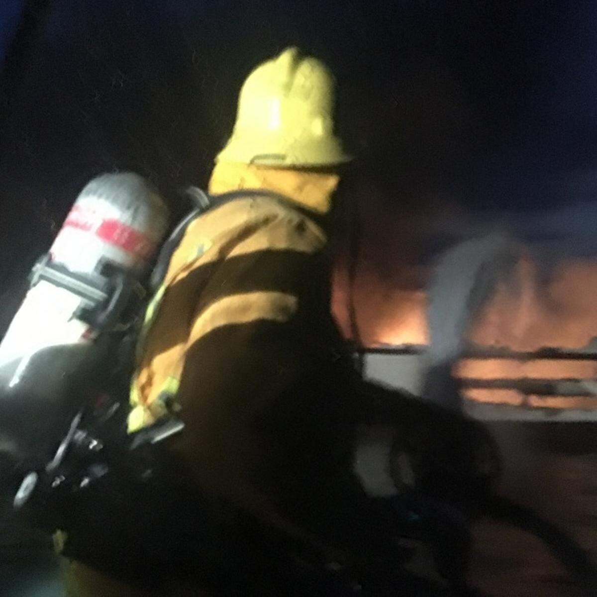 Santa Barbara Harbor Patrol Officer Karl Halamicek directs water and foam on the Conception in the pre-dawn hours.
