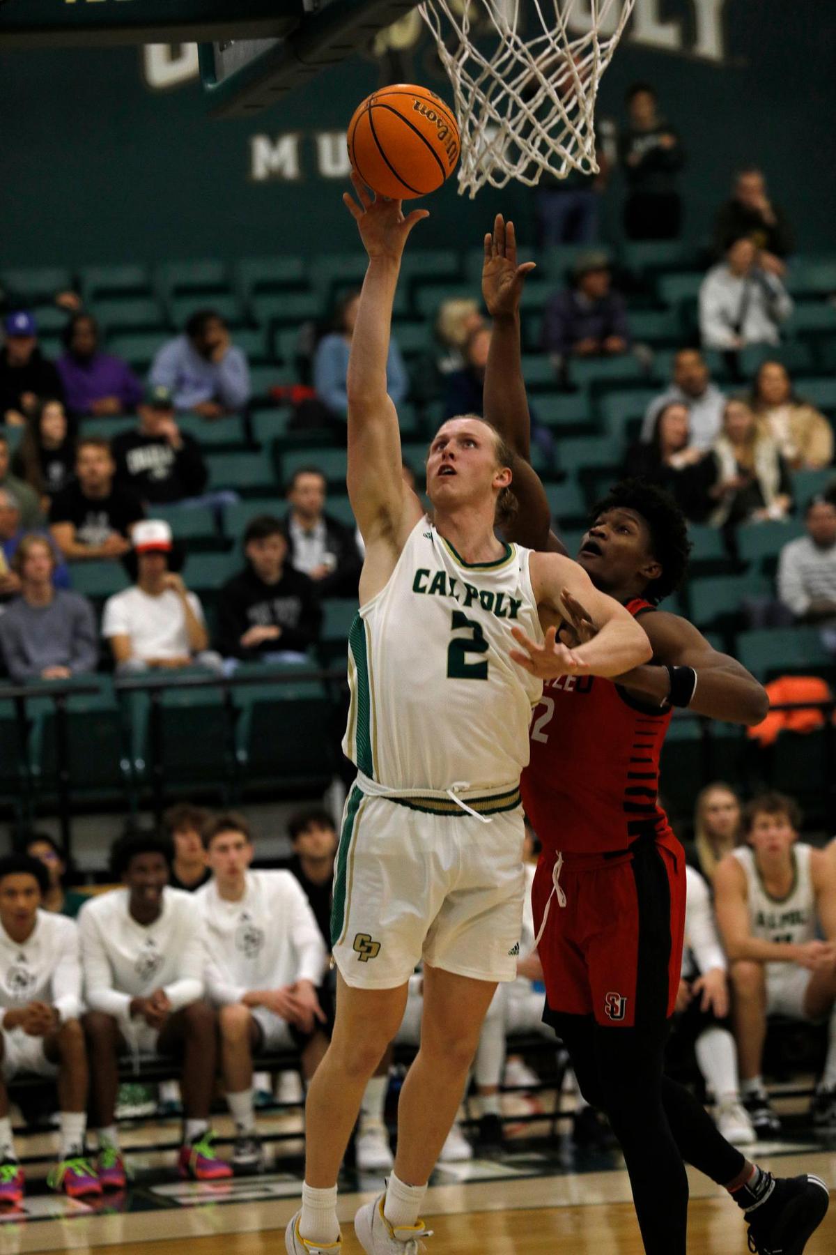 Cal Poly’s Mac Riniker goes for a basket while Seattle University’s Matthew-Alexander Moncrieffe defends. Cal Poly beat Seattle University 75-71 in a college basketball game at Mott Athletics Center on Nov. 14, 2024.