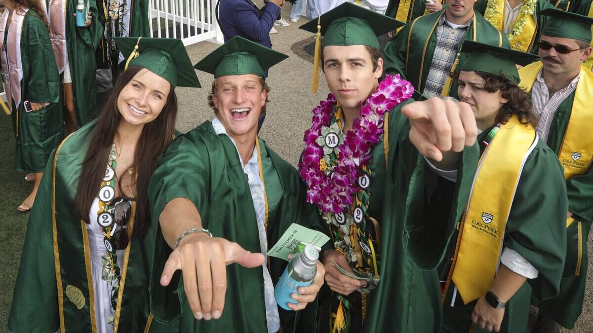Zetta Espinola, left. Dominic Cipolla and Mason Schmid walk in to ceremony. Cal Poly held the first of six graduation ceremonies at Spanos Stadium on June 13, 2026. The College of Agriculture, Food and Environmental Science held the first ceremony.