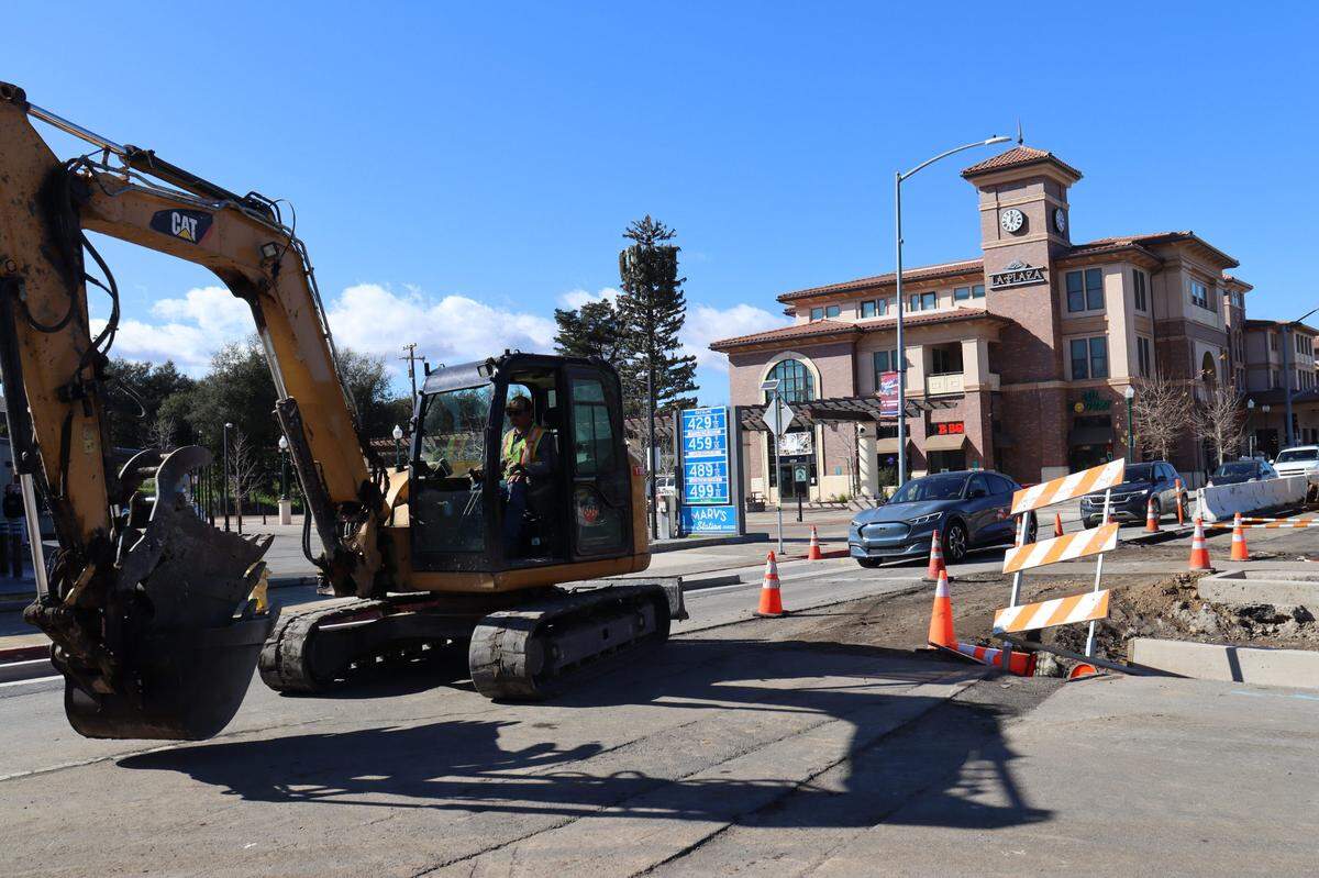 A line of cars waits backed-up behind a slowly moving excavator on El Camino Real in downtown Atascadero. Construction began in June 2024 and will last until the summer of 2025.