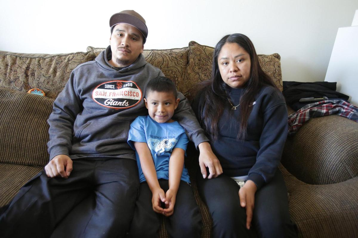 Jose Gutiérrez’s parents,  Francisco Gutiérrez and Maria Orozco, sit on their couch with their 6-year-old son, Luis, on May 28, 2025.