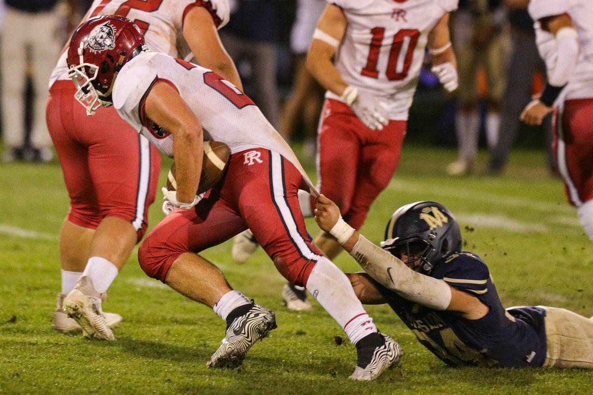 Mario Luera makes a shirt tackle of Leo Kemp. Mission Prep defeated Paso Robles 28-7 in a football game on Sept. 30, 2022, in San Luis Obispo.