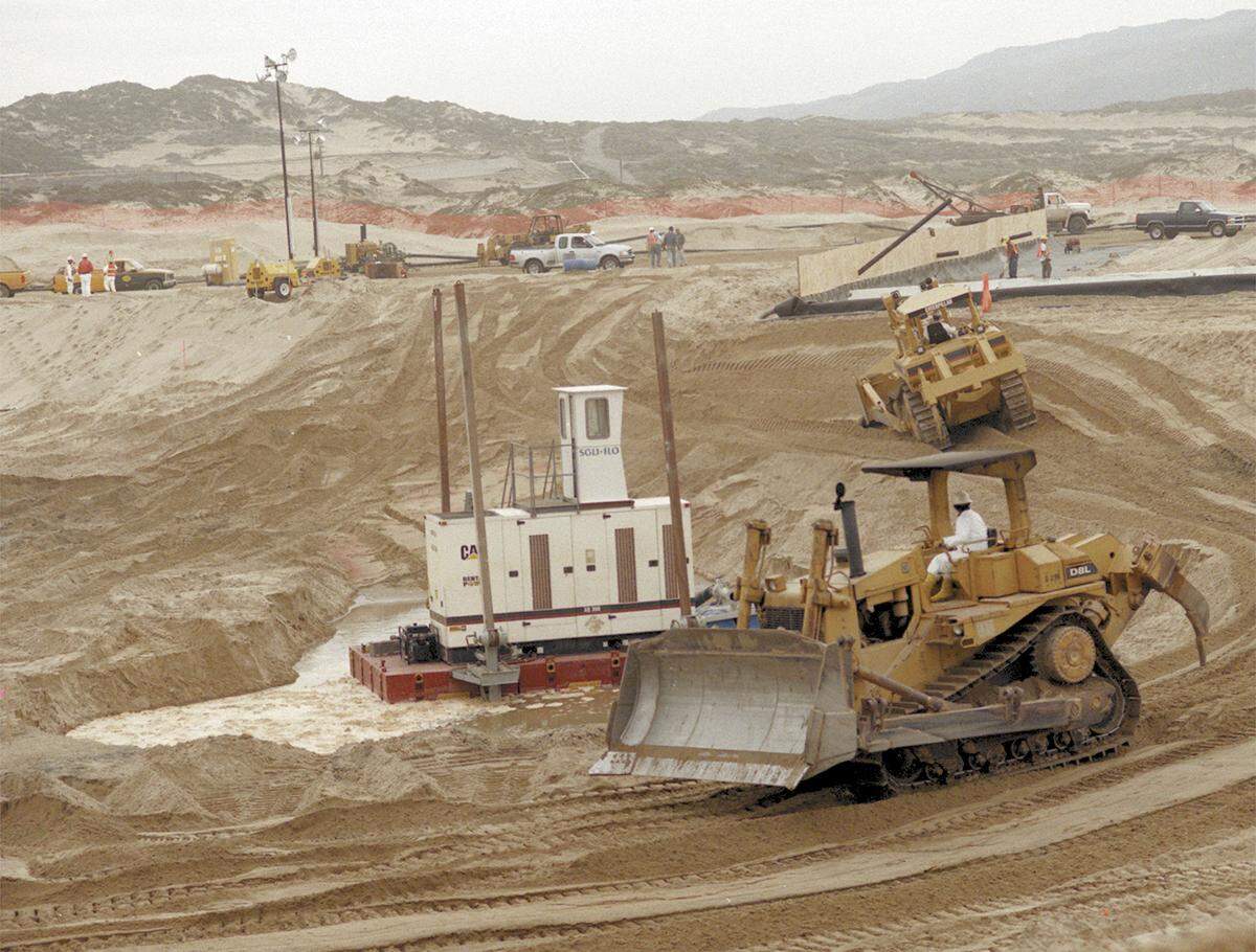NOVEMBER 1997: The Unocal cleanup of Guadalupe Dunes oilfield is in progress and crews hustle to shore up the beach against possible heavy surf erosion from El Niño.