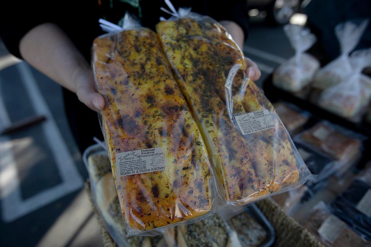 Dusty and Kristin Stewart of Household Baking Co. operate a cottage-industry bakery out of a tiny commercially licensed kitchen in a family cabin west of Paso Robles in Running Deer Ranch. Kristin Stewart holds loaves of Firebread Focaccia.