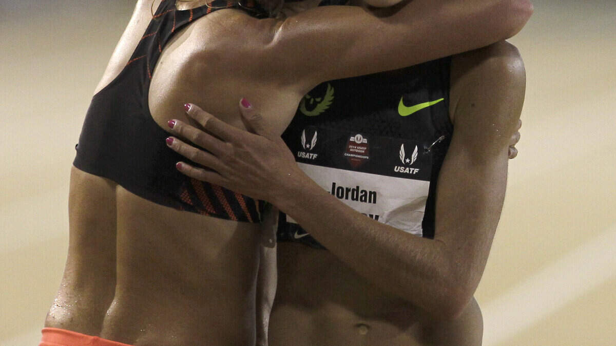 Kim Conley, left, who won the women's 10,000 meters, gives second-place finisher Jordan Hasay a hug at the US outdoor track and field Championships in Sacramento, Calif., Thursday, June 26, 2014..(AP Photo/Rich Pedroncelli)
