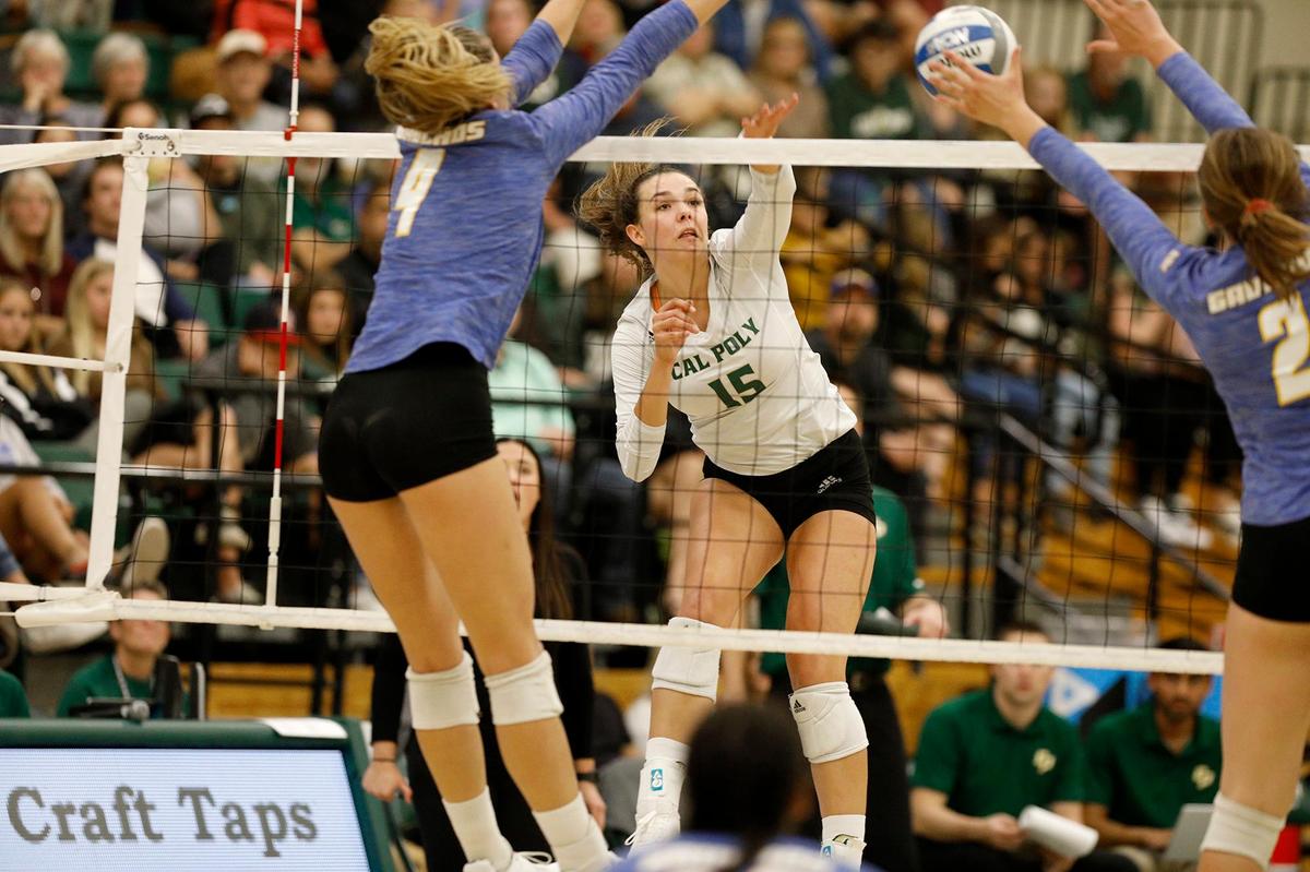 Maia Dvoracek spikes the ball at UCSB defenders Rowan Ennis (2) and Lindsey Ruddins (4) during Cal Poly’s 3-0 sweep of the Gauchos on Saturday night at Mott Athletics Center.