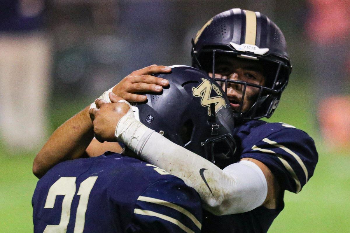 Drew Harrigan gets a hug after scoring. Mission Prep beat Arroyo Grande 41-35 in a Mountain League football game on Oct. 14, 2022.