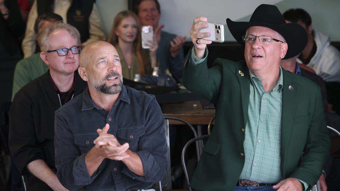 Cal Poly President Jeffrey Armstrong takes a video of the crowd. At left are Matt Lazier, assistant vice president, communications and media relations and Chris Murphy, vice-president for communications. An audience of about 300 witnessed the splashown of the Artimism II mission around the moon April 10, 2026 at Cal Poly's University Union.