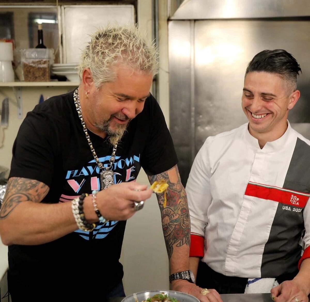 Food Network Chef Guy Fieri, left, tastes a bite of pasta from Flour House in San Luis Obispo. Alberto Russo, right, is the chef and co-owner of the downtown Italian restaurant.