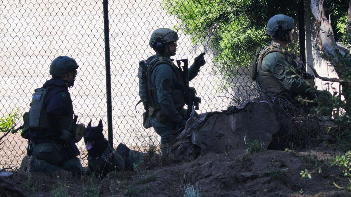 Sheriff’s deputies keep a house under observation during a standoff that was sparked by an argument and gunfire in the Bluff Pointe neighborhood of the Nipomo Mesa on Sept. 18, 2023.