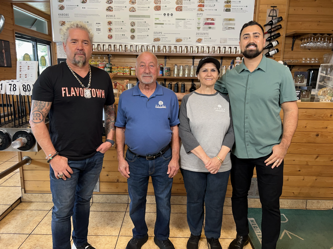 Guy Fieri, left, visited Petra Mediterranean Pizza and Grill, the family-owned SLO restaurant owned by, from left, Todd, Sana and Rammy Aburashed. The restaurant will be featured on “Diners, Drive-ins and Dives” on Aug. 2, 2024.