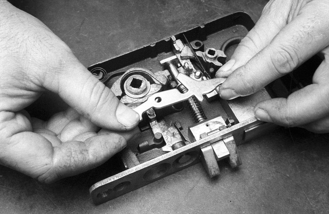 Locksmith Gene Nowicki rebuilds an intricate classroom lock mechanism at Cal Poly on Nov. 17, 1978.