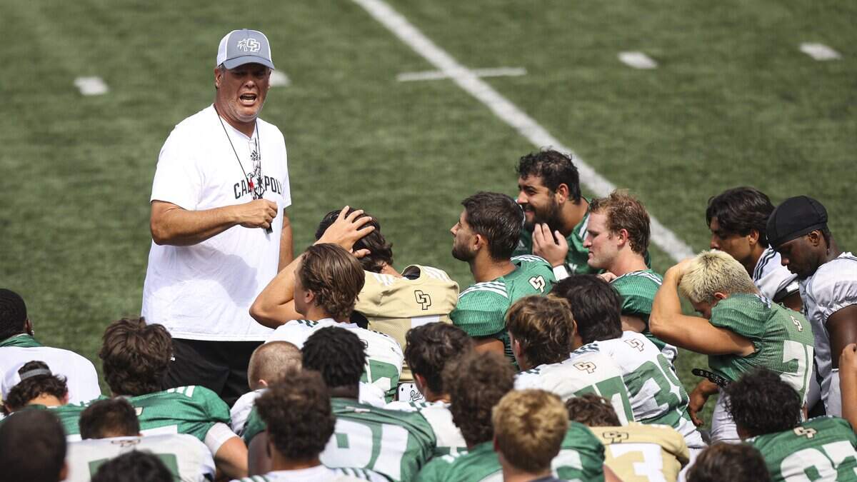 Head coach Paul Wulff talks to team after Cal Poly football scrimmage at Musting Memorial Field on Aug. 22, 2025.