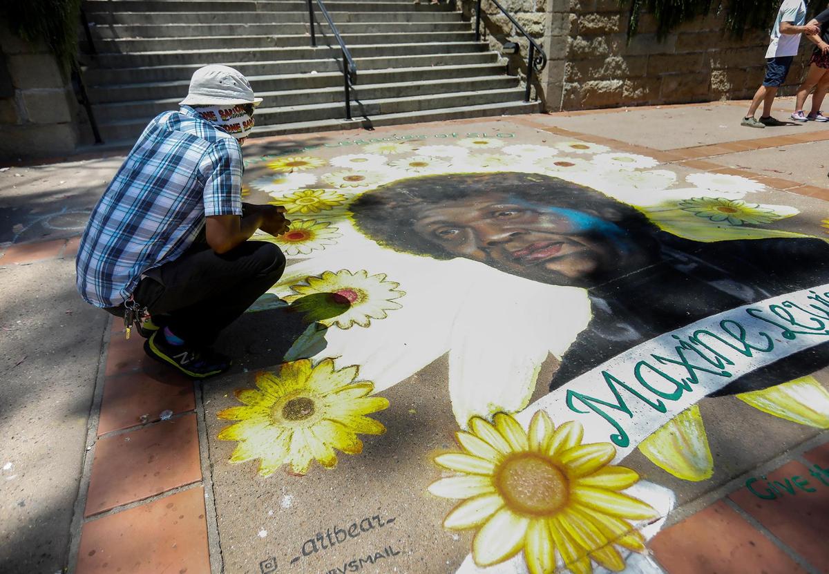 A chalk mural honoring Maxine Lloyd Lewis — for whom the former homeless shelter on SLO’s Prado Road was named — is located in Mission Plaza. Lewis was best known for her work as an activist on behalf of community members in need in San Luis Obispo. Lloyd’s grandson, Zack Harris, a San Luis Obispo native, gazes at her portrait.