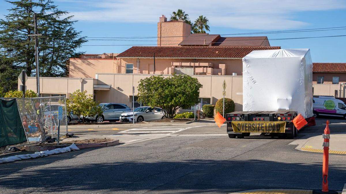 A semi-truck backs a 3D-printed home onto the Welcome Home Village project site on Friday, Nov. 21, 2025. The homes were produced at a facility in Gardena and shipped to San Luis Obispo in late 2025.