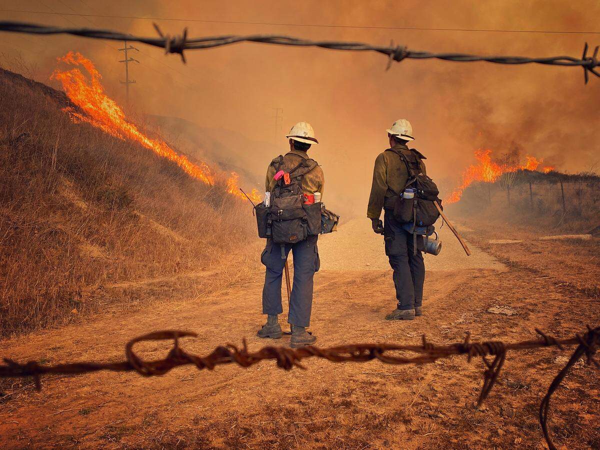Santa Barbara County Fire Department hand crew members burn off pockets of grass along northbound Highway 101 north of Arroyo Hondo Canyon. The Alisal Fire had burned 14,500 acres as of Wednesday, Oct. 13, 2021.