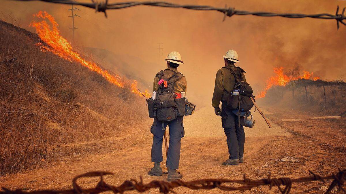 Santa Barbara County Fire Department hand crew members burn off pockets of grass along northbound Highway 101 north of Arroyo Hondo Canyon. The Alisal Fire had burned 14,500 acres as of Wednesday, Oct. 13, 2021.