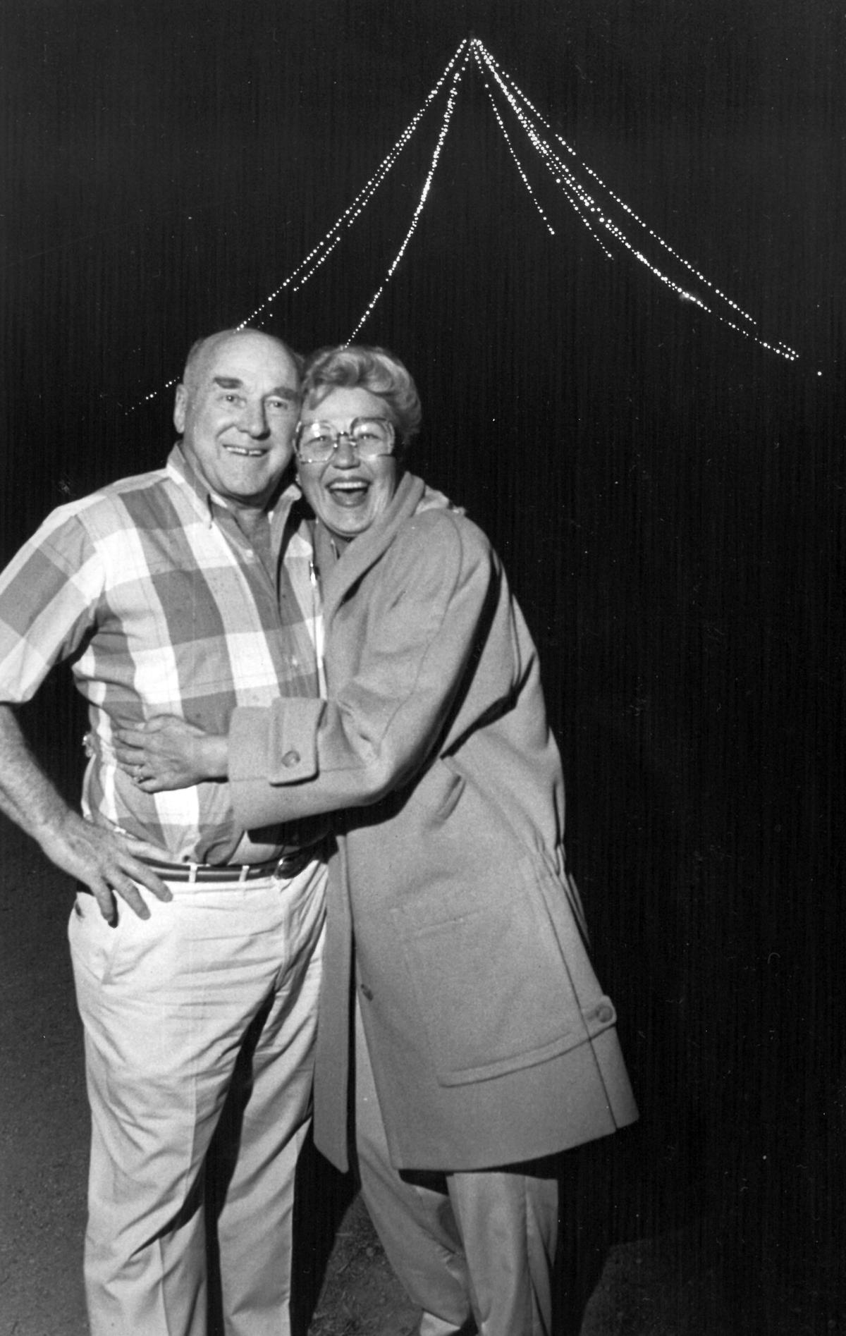 Alex and Phyllis Madonna stand at the top of San Luis Obispo Mountain in Dec. 1986 near the Christmas tree they relit this yule season after an absence of many years. The tree lighting started out to be a one day surprise birthday present from Phyllis to Alex, but they decided to keep it lit throughout the holiday season. Although there have been a few complaints and some vandalism to the lighted tree they have received numerous letters thanking them for relighting the mountaintop ornament. The Madonnas think of the tree as their Christmas card to the community. Tony Hertz/Telegram-Tribune first published 12-24-1986
