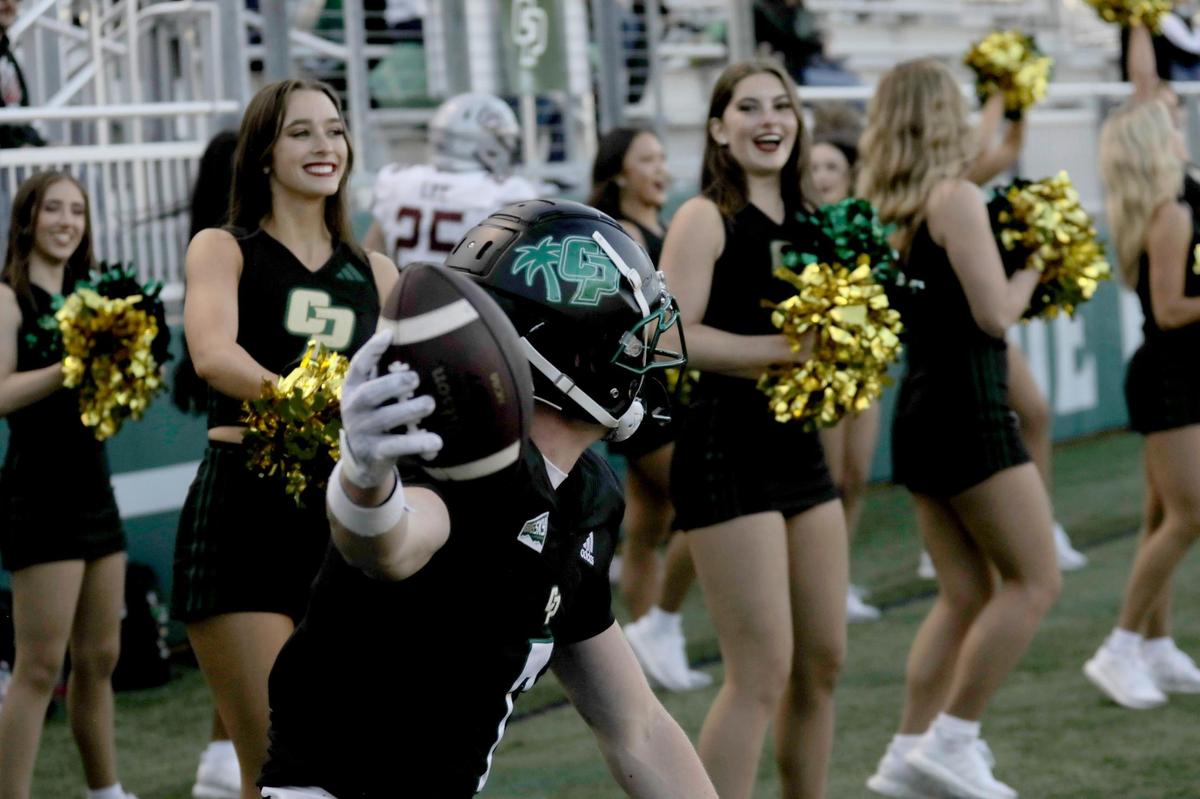 Cal Poly cheerleaders cheer Jake Wood after he scored the Mustang’s only touchdown of the game. Cal Poly lost to Montana 42-7 in a college football game at Mustang Memorial Stadium on Nov. 2, 2024.