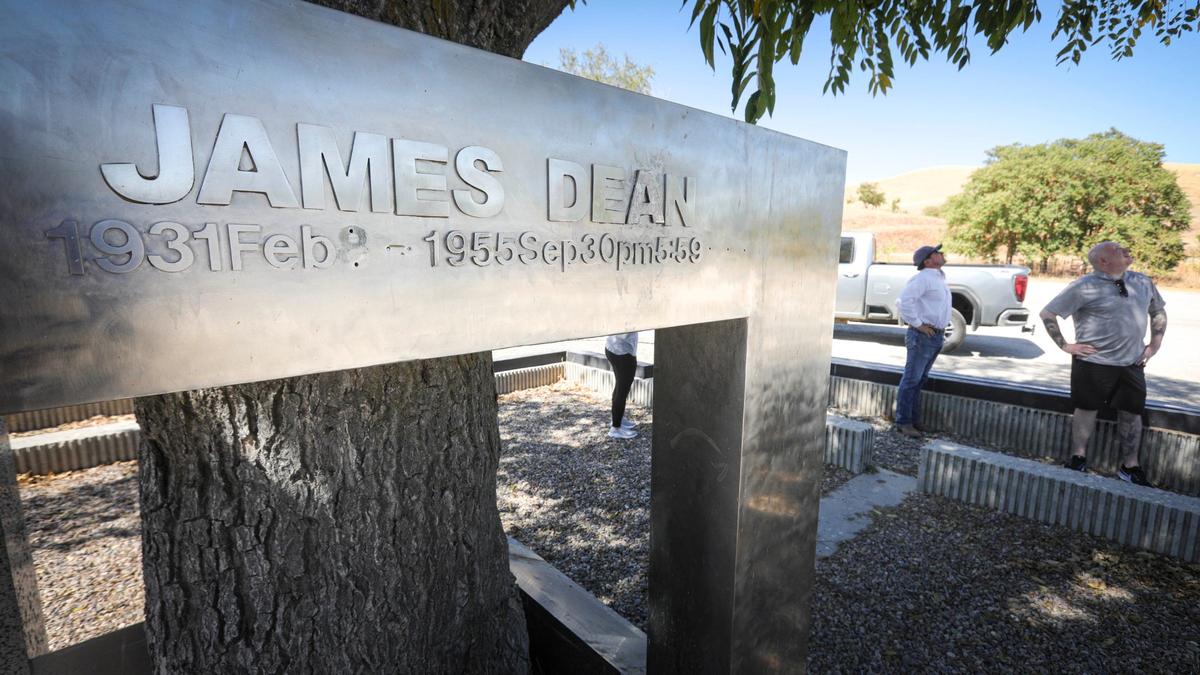 James Dean memorabilia collector Neil Sheehan, right, is organizing an effort to restore the 1977 memorial to the famed movie star who died east of Cholame in a 1955 car wreck. He talks to Ben Higgins, director of agricultural operations at Hearst Corp., which owns the Jack Ranch property around Cholame.