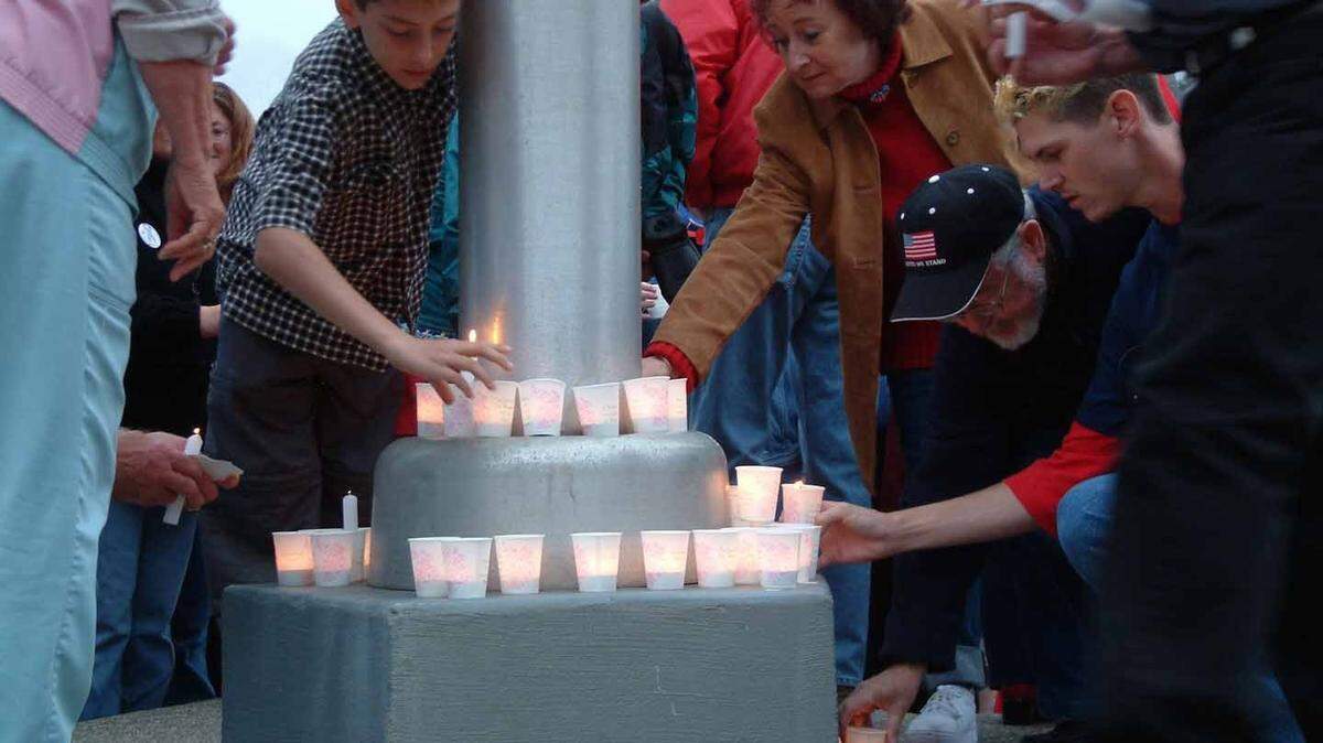 People gather in Cambria on Sept. 11, 2001, to light candles for those killed in the World Trade Center and Pentagon attacks.