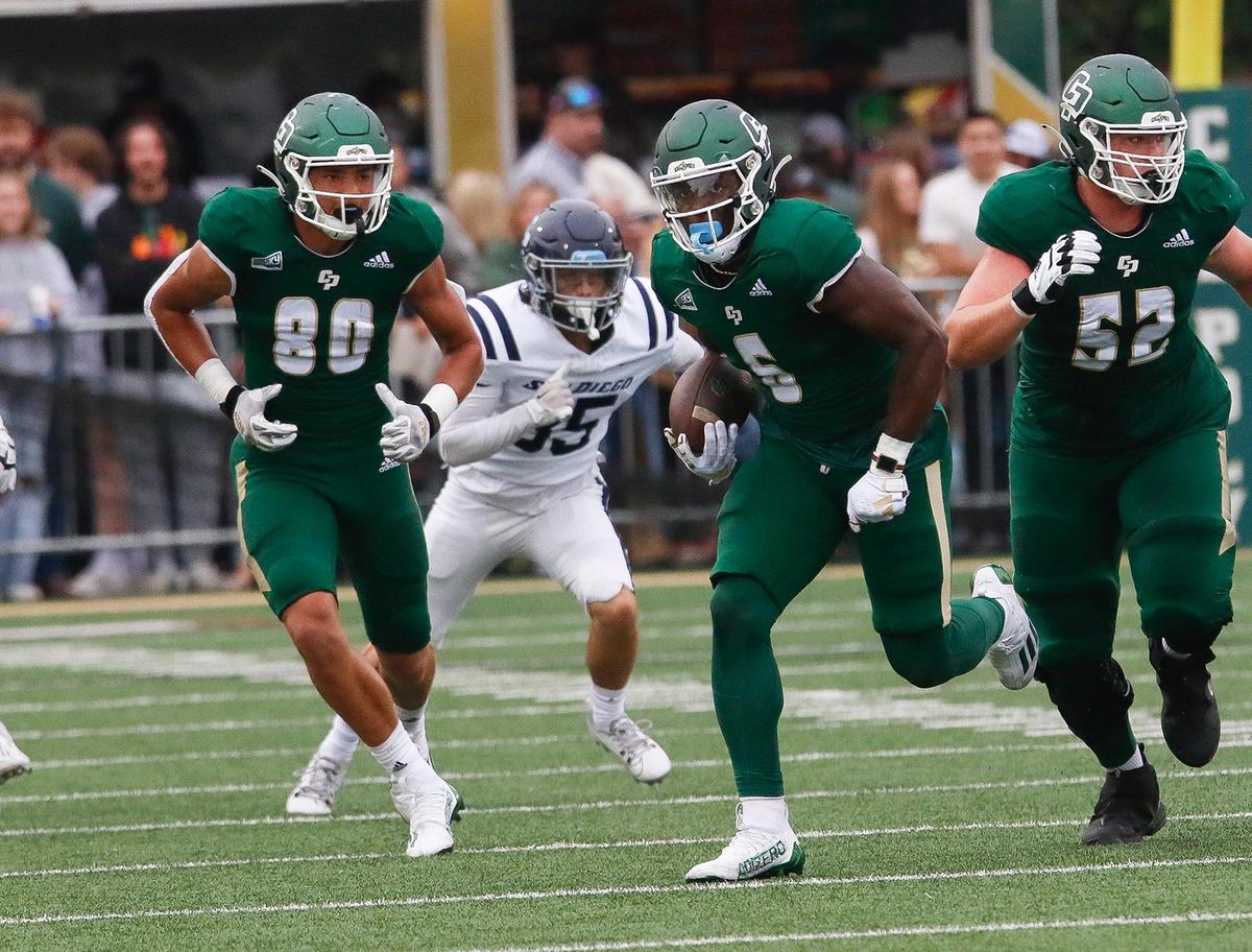 Mustang ball carrier Xavier Oliphant (6) is trailed by Carlton Brown (80) and Payson Campisano (52) in Cal Poly’s 27-10 win over the University of San Diego at Alex G. Spanos Stadium on Sept. 2, 2023.