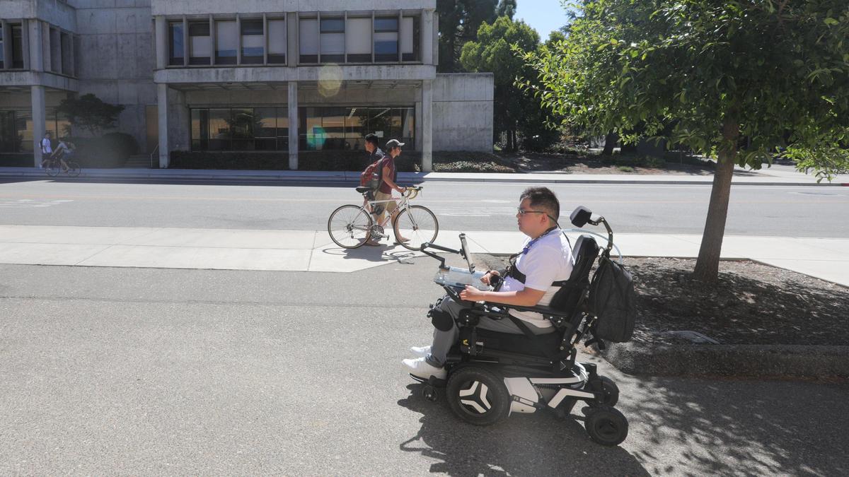 Cal Poly student Alexander Fung navigates campus in his motorized wheelchair.