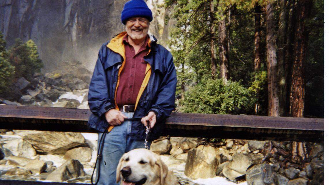 Retired physicist Darrell Gusner poses for a photo at Yosemite National Park with his late guide dog Geppeto.