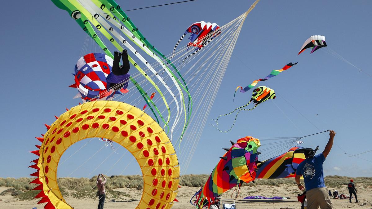 Giant kites brought by brothers Robert and Michael Macias of Merced fly in the sky for the Morro Bay Kite Festival in 2018. The festival returns to the beach north of Morro Rock in April 2022.