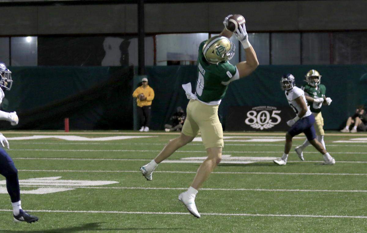 Mustang Logan Booher catches a pass. Cal Poly lost to UC Davis 34-27 in a college football game at Mustang Memorial Stadium on Oct. 4, 2025.