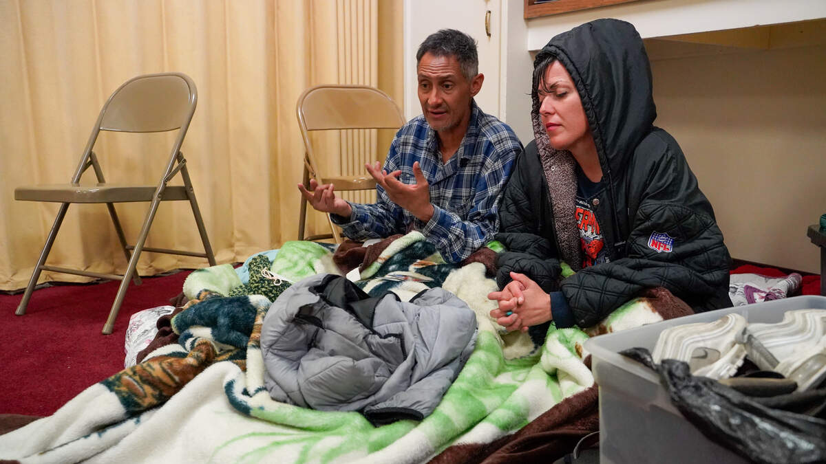 Homeless San Luis Obispo County residents Raymond Rose and Mia Pasquale settle in for the night at a volunteer warming center operated by volunteer organizations Paso Cares and Hope and Faith Street Outreach, pictured here Wednesday, Feb. 12, 2025.