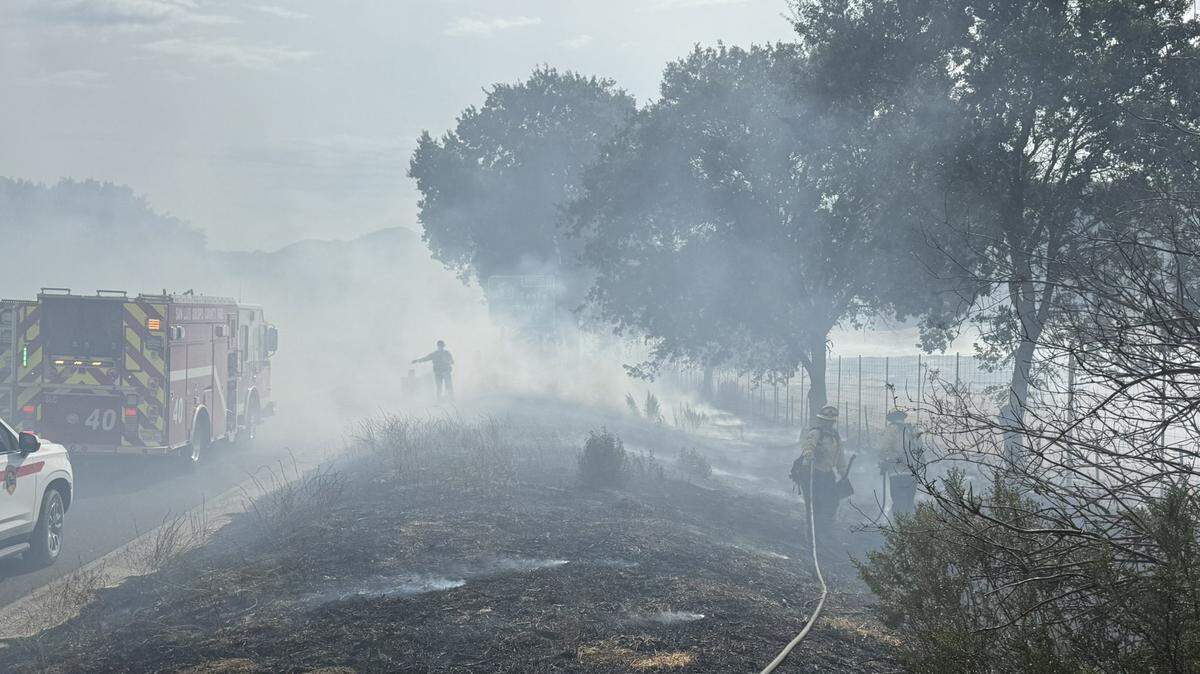 Cal Fire works to extinguish a blaze on Highway 101 near Santa Margarita on Wednesday, Sept. 17, 2025.