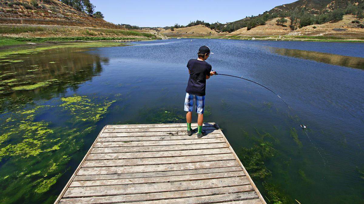 Forrest Martinez, 12, casts his line into the waters of Santa Margarita Lake. A few minutes earlier he pulled in a 14 inch bass, he said.
