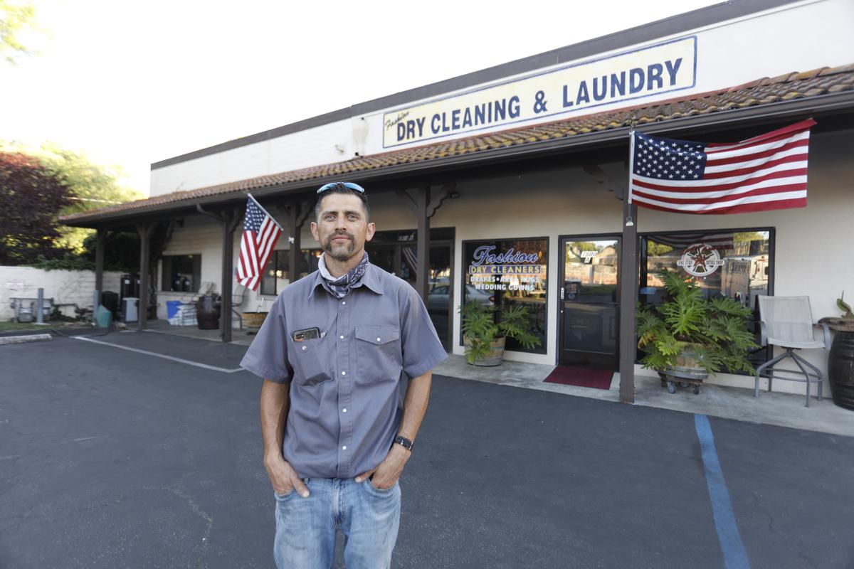 Junior Gonzales stands outside his family’s Atascadero business, Fashion Dry Cleaners & Laundry. He said his 1-1/2-year-old pit bull was hit in the face, the front leg and the back when it was shot by a SLO County sheriff’s deputy who thought a burglary was in progress.